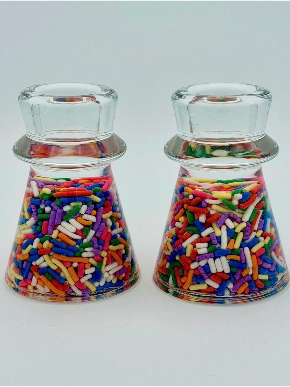 Clear Glass Candle Holder For Taper Candles Filled With Rainbow Sprinkles